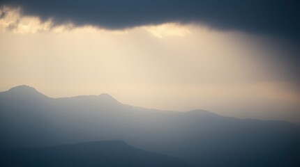 Fototapeta premium Mountain Peaks Through the Clouds: A dramatic and ethereal landscape photograph of mountain peaks piercing through a veil of clouds, illuminated by a soft, golden light.