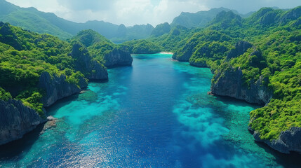 Obraz premium Aerial footage of a tropical lagoon with a mix of deep blue and emerald green waters surrounded by lush cliffs