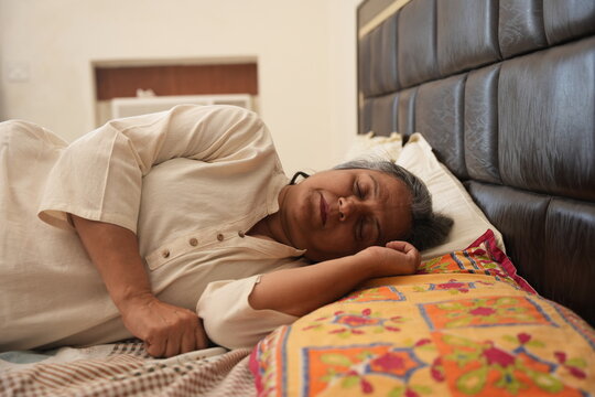 senior indian woman sleeping in bed. resting and relaxation concept. 
