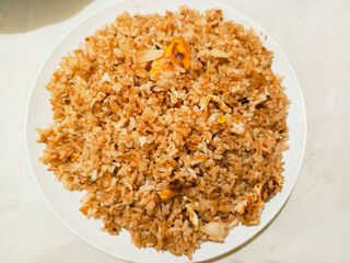 photo of mother's homemade village fried rice for breakfast placed on a white plate