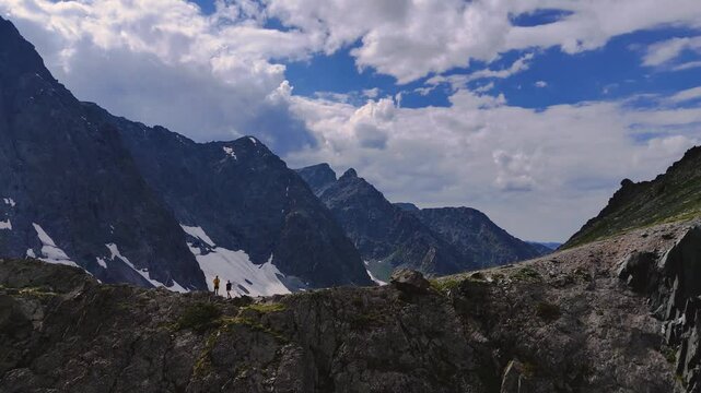 two tourists on the Kuyguk pass in summer in Altai