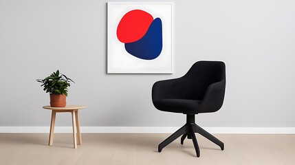Modern minimalist interior with black chair, abstract art, and small plant.