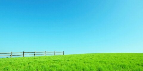 Fototapeta premium Serene Pasture Landscape A Vibrant Green Field Under a Clear Blue Sky with a Rustic Wooden Fence