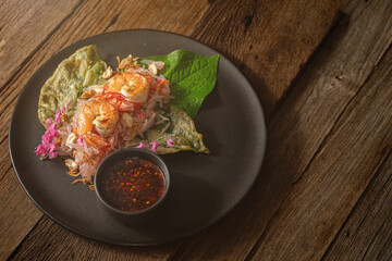 Traditional Thai Salad with Pomelo, Shrimp, and Betel Leaves on Black Plate