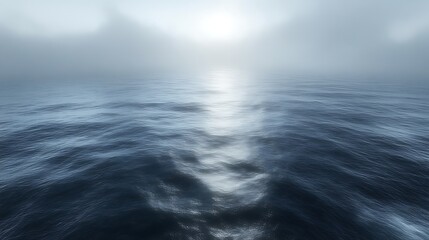 Misty ocean sunrise with sun reflection on water.