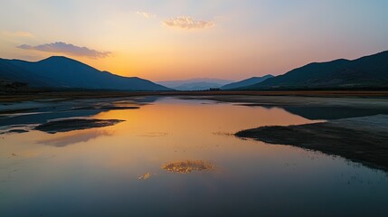 Fototapeta premium Colorful lake reflecting the sky at sunset, surrounded by mountains in China, no people, ample copy space