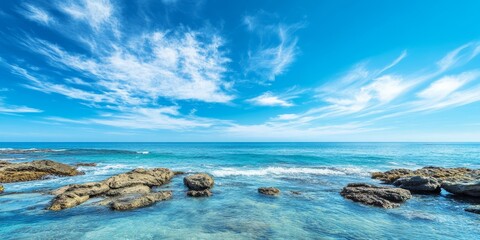 Seaside view under a bright blue sky, showcasing the beauty of the seaside and the vibrant hues of a clear blue sky, perfect for illustrating coastal landscapes and tranquility.
