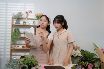 Gardeners florist at her own floral shop taking care of flowers.