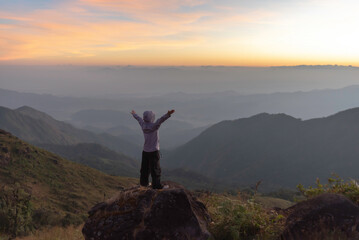 Lifestyle traveler happy feeling good relax and freedom facing in the sunrise morning. Travel Concept