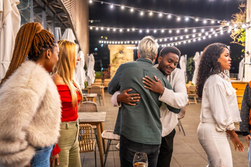 Friends hugging while arriving in a meeting