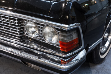 Fototapeta premium Headlight and chrome details of an old timer car. Close up photo