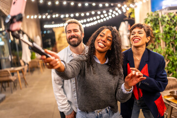 Latin woman streaming online during night party