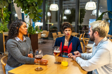 Coworkers enjoying beer together after work outside a bar