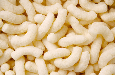 Crispy corn snacks background.