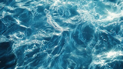 Obraz premium Clear blue water wave texture with ripples and splashes under sunlight, perfect for cosmetic ads featuring micellar toner, moisturizer, or emulsions.