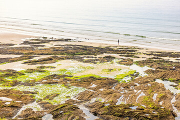 Cliffs with seaweed by the sea