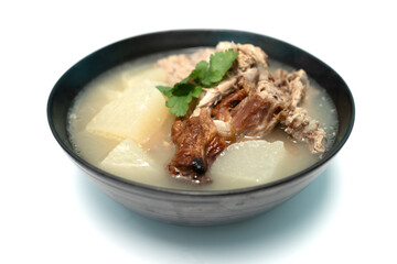 Stewed radish with roasted duck bones on isolate white background, Close up.