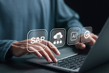 Person using laptop with SAP icon on virtual screen for business process automation software and management software, SAP or ERP enterprise resources planning system concept.