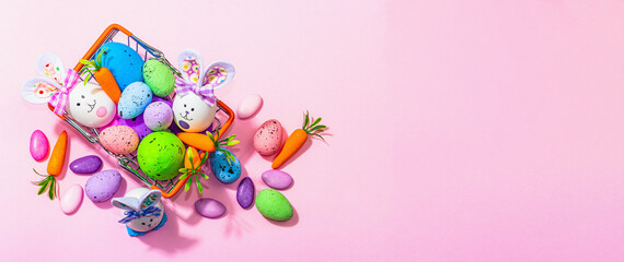 Easter sale concept. Shopping basket with festive symbols - rabbit, eggs, bird, traditional decor