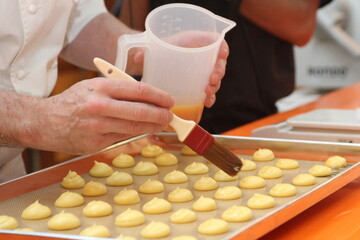 brushing choux pastry with egg whisk