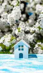 The symbol of the house stands against a background of cherry blossoms
