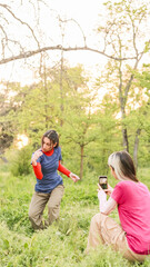 Obraz premium Hikers taking pictures in the woods during hiking trip
