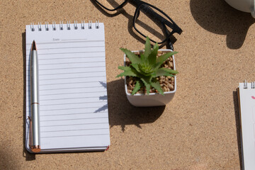 Organized Workspace: Pen, Eyeglasses, Empty Note, Calendar, and Coffee Cup
