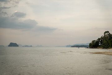 Quiet beach with trees and distant islands