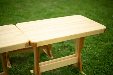 A wooden table on green grass. Empty wooden table.
