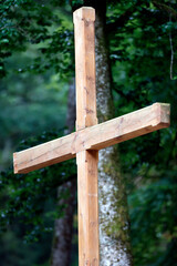 Wooden cross in nature. Christian symbol. Faith and spirituality.