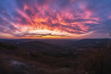 Fototapeta premium Breathtaking colorful sunset panorama over rural hills and fields