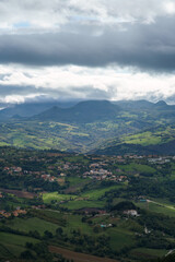 Fototapeta premium San Marino countryside with distant mountains under a cloudy sky