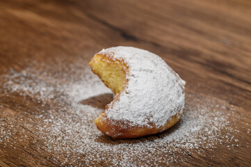 Nadgryzione ciastko, izolowany pączek z cukrem pudrem z bliska