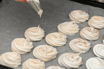 Whipping up sweet delights with meringue cookies in a cozy kitchen