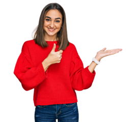 Beautiful brunette woman wearing casual winter sweater showing palm hand and doing ok gesture with thumbs up, smiling happy and cheerful