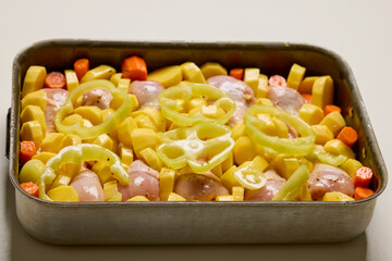 raw chicken thighs with vegetables ready to be cooked