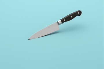 A modern stainless steel knife displayed on a pastel blue background