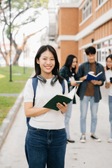 Obraz premium Asian Students are studying the campus park. Young people are spending time together. Reading book, working with laptop and tablet