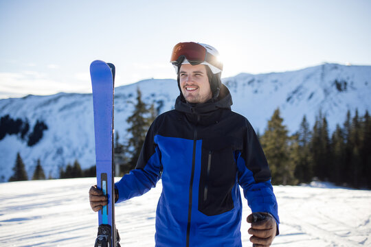 Smiling skier with blue jacket in Kitzb&uuml;hel&rsquo;s snowy mountains