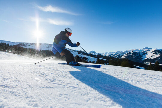 Dynamic skier carving through fresh snow in Kitzb&uuml;hel, Austria