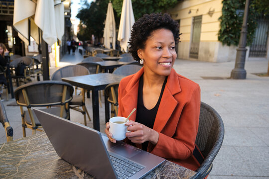 Professional woman working remotely at a cafe