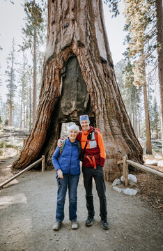 Elderly woman poses for picture with middle aged son, Yosemite