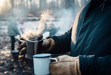 Person With Leather Gloves Holding Steamy Drink In Danish Forest