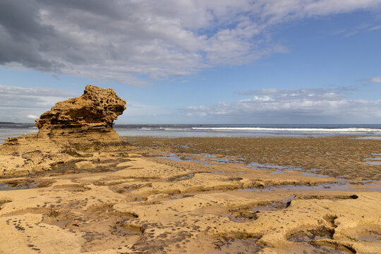 Large rock formation on rugged coastline in Point Lonsdale