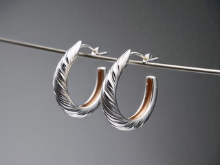 a pair of simple hoop silver earrings, clean background