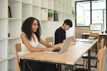 Young businesspeople collaborating in a stylish open office space.