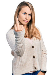 Young blonde woman wearing casual clothes showing middle finger, impolite and rude fuck off...