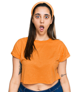 Young hispanic woman wearing casual clothes afraid and shocked with surprise and amazed expression, fear and excited face.