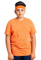 Little boy kid wearing sportswear making fish face with lips, crazy and comical gesture. funny expression.
