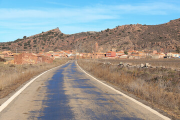 Lonely road to Peracense town and the rodeno red stone mountains in the background